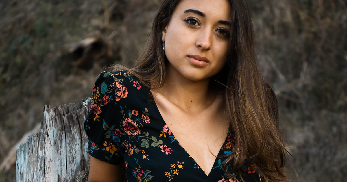 A photo of a Colombian woman wearing a floral crop top