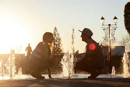 man and woman with a water fountain in between