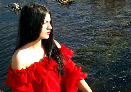 A photo of a Latina wearing a red top