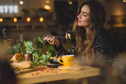  A photo of a beautiful Latina woman enjoying her meal at a nice restaurant