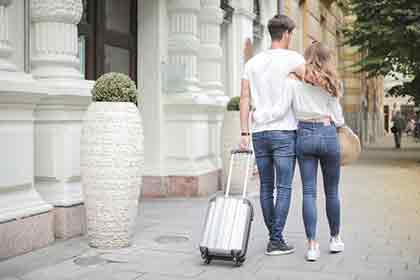 A happy couple going on a trip together.