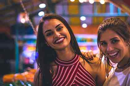 A Photo of two beautiful Colombian women smiling.